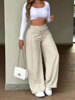 Women's casual wide-leg trousers with vertical pleats.